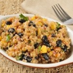 A dish of black beans and quinoa with vegetables.