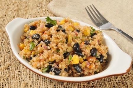 A dish of black beans and quinoa with vegetables.