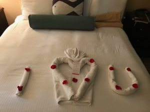 towels rolled into I love (shape of heart) the letter U left by our room attendant at omni hotel