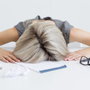 Exhausted Woman's head on desk