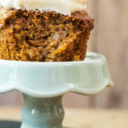 Carrot muffin with icing on blue pedestal