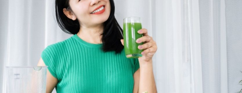 women drinking green drink