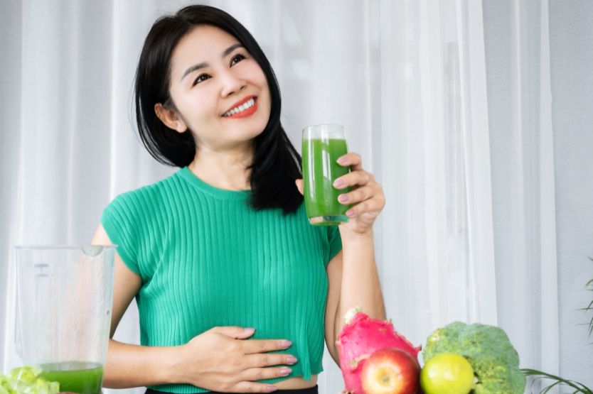 women drinking green drink